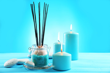 Spa composition of blue candles, stones and sea salt on blue background