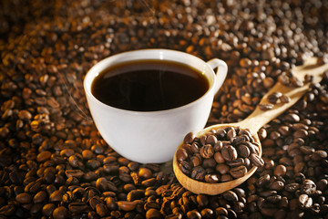 Cup of coffee and coffee beans closeup