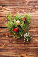 Christmas bouquet of fir tree branch with christmas balls on wooden background