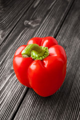 Red bell pepper on black and white wooden background
