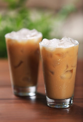 Cups of ice coffee on wooden table