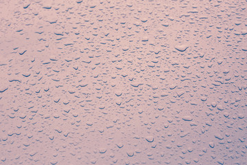 Drop water rain on the pink car in close up background and textu