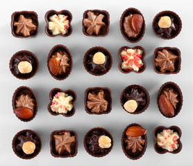 Delicious chocolate candies on white background
