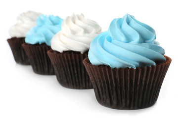 Fresh delicious cupcakes in a row isolated on white background