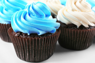 Fresh delicious cupcakes in a row, close up