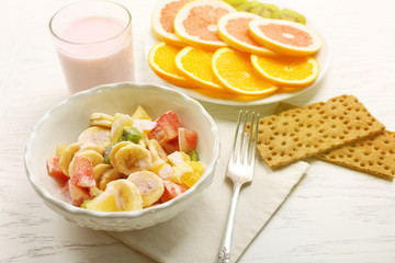 Fruit salad on wooden background. Healthy eating concept.