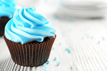 Blue cupcakes on wooden table