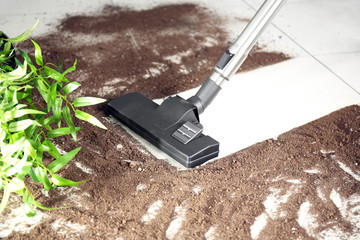 Vacuum cleaning after falling flower pot on a tiled floor