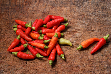 Red chili pepper on old wooden chopping board