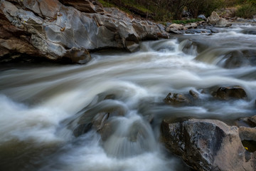 Naklejka premium creek flowing over the rocks