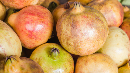 pomegranate ripe unattractive on basket in maket