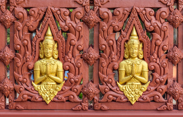 Row of Buddha statues on Buddhist temple wall