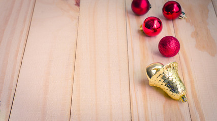 Bell and red ball on wooden background