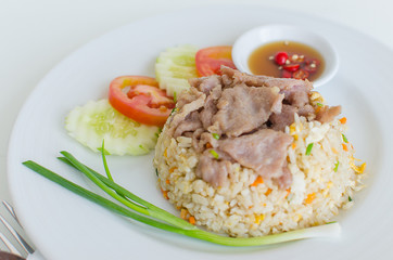 fried rice with pork and chili sauce in dish, selective focus