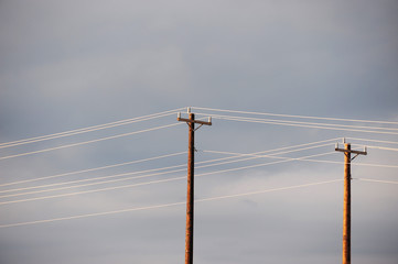 power poles against cloudy sky