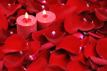 red candles and rose petals background