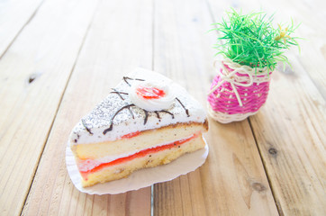 Piece of Vanilla Cake on wood table style vintage