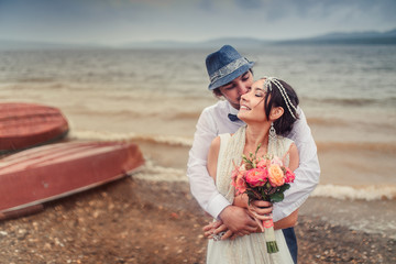 Boho wedding. beautiful couple kissing on the coast
