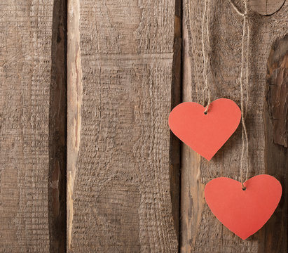 vintage red hearts on wooden background