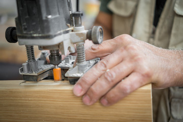 Blurred motion of carpenter working, preparing door for hinges