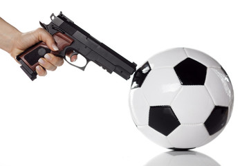 female hand aim a football with a gun