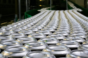 Conveyor line carrying thousands aluminum beverage cans at factory