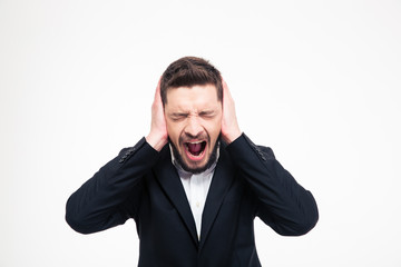Businessman covering his ears and screaming