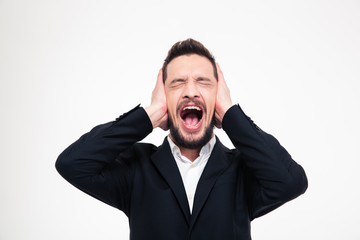 Angry businessman covering his ears and screaming