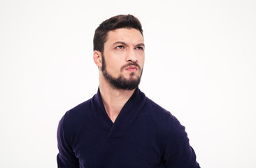 Obraz premium Dissatisfied frowning handsome young man with beard in sweetshirt