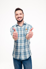 Smiling attractive young man showing thumbs up with both hands