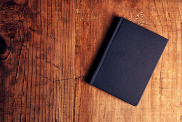 Black notebook on wooden office desk