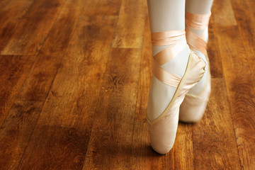 ballerina in Pointe on a wooden floor