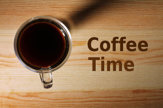 Fototapeta Cup with strong coffee on a wooden table with inscription at the top