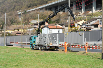 Workers during the installation of noise barriers on the railway