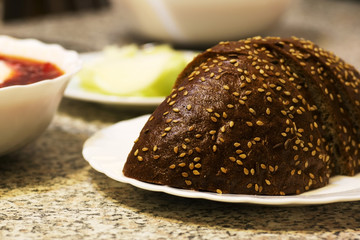 Sliced loaf of rye bread lying on the saucer