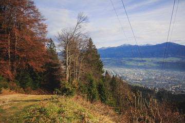Beautiful super wide-angle aerial view of Innsbruck, Austria with skyline, Alps mountains and scenery beyond the city, and Inn river 