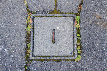 Old square cement manhole cover