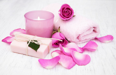 Bath towels, candle and soap with pink roses