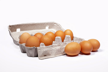 Chicken's eggs in box grey color on white background