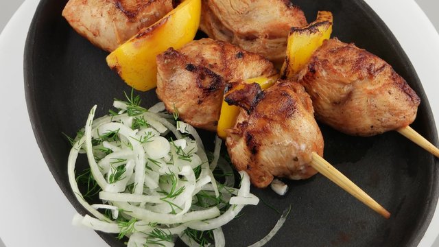 Grilled chicken meat with onion on a frying pan