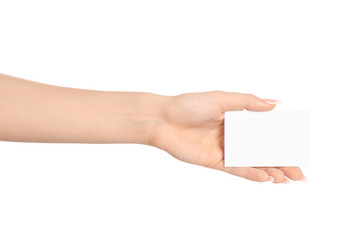 Branding and advertising theme: beautiful female hand holding a blank white paper card isolated on white background