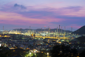Fototapeta na wymiar Oil refinery among the city at twilight.