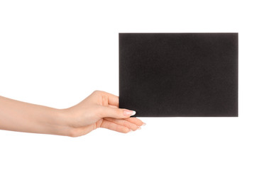 Branding and advertising theme: beautiful female hand holding empty black paper card isolated on white background
