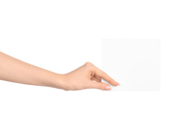 Branding and advertising theme: beautiful female hand holding a blank white paper card isolated on white background - 98616194