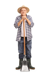 Mature agricultural worker posing with a shovel