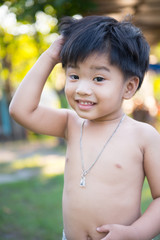 outdoor portrait of a little asian boy.