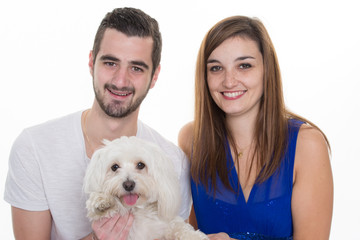 Couple with a white dog  isolated on white background
