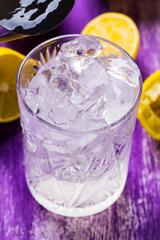 Glass of ice cubes on the wooden background
