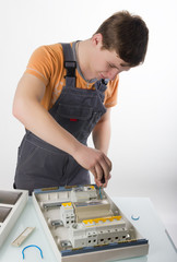 Obraz premium electrical appliance repairs. electrician fixing cable in domestic electrical box