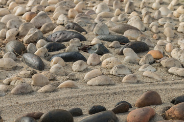 Mini stone with sunlight bury on sand ,Selective focus